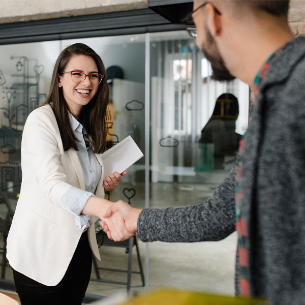 Two people shaking hands before a job interview