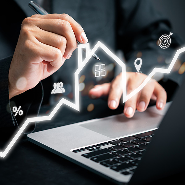 A person using a laptop with an image of a house representing a digital search of property information